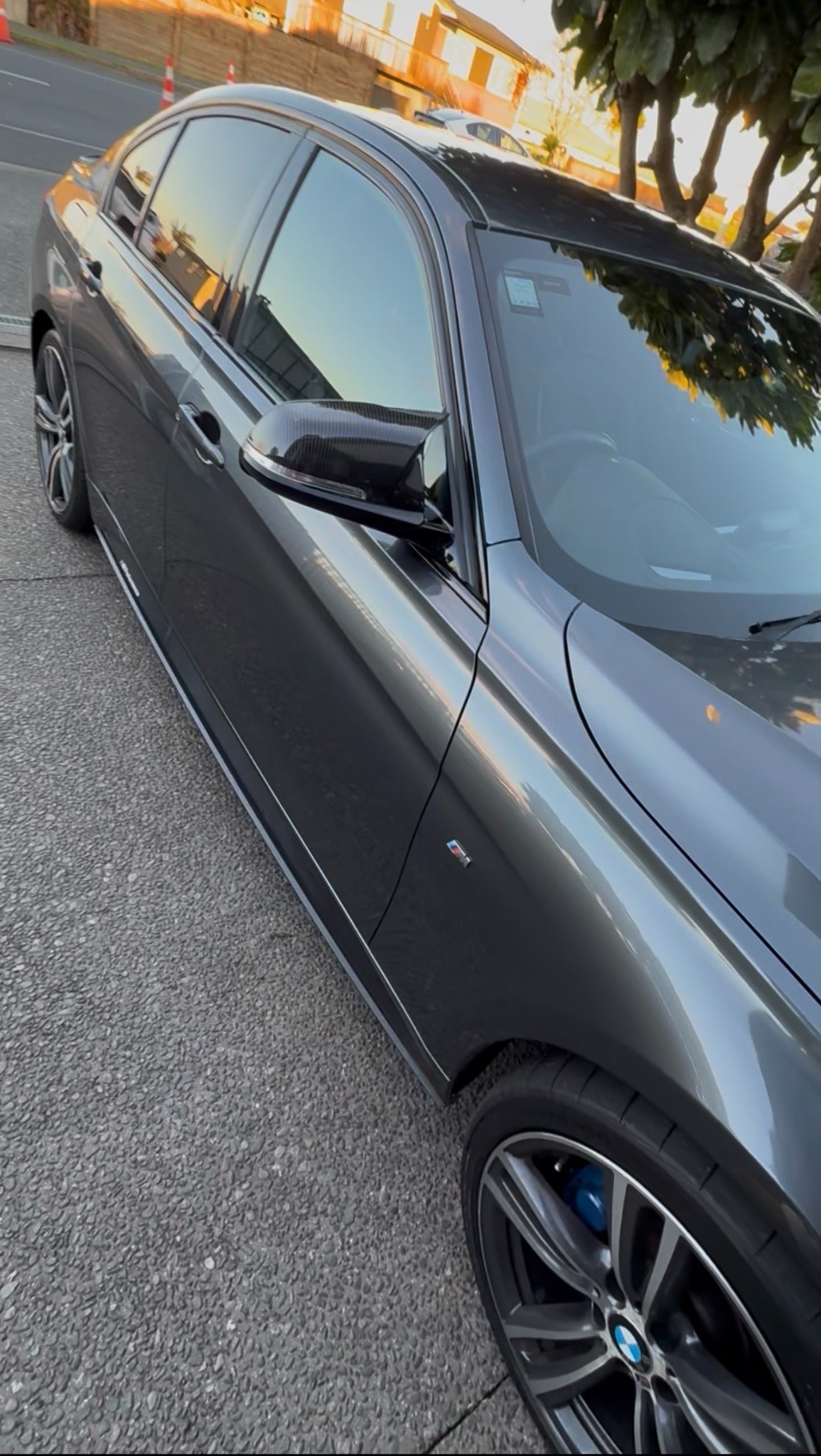 Grey BMW side view after carbon mirror cap upgrade photographed for Apex Euro Styling