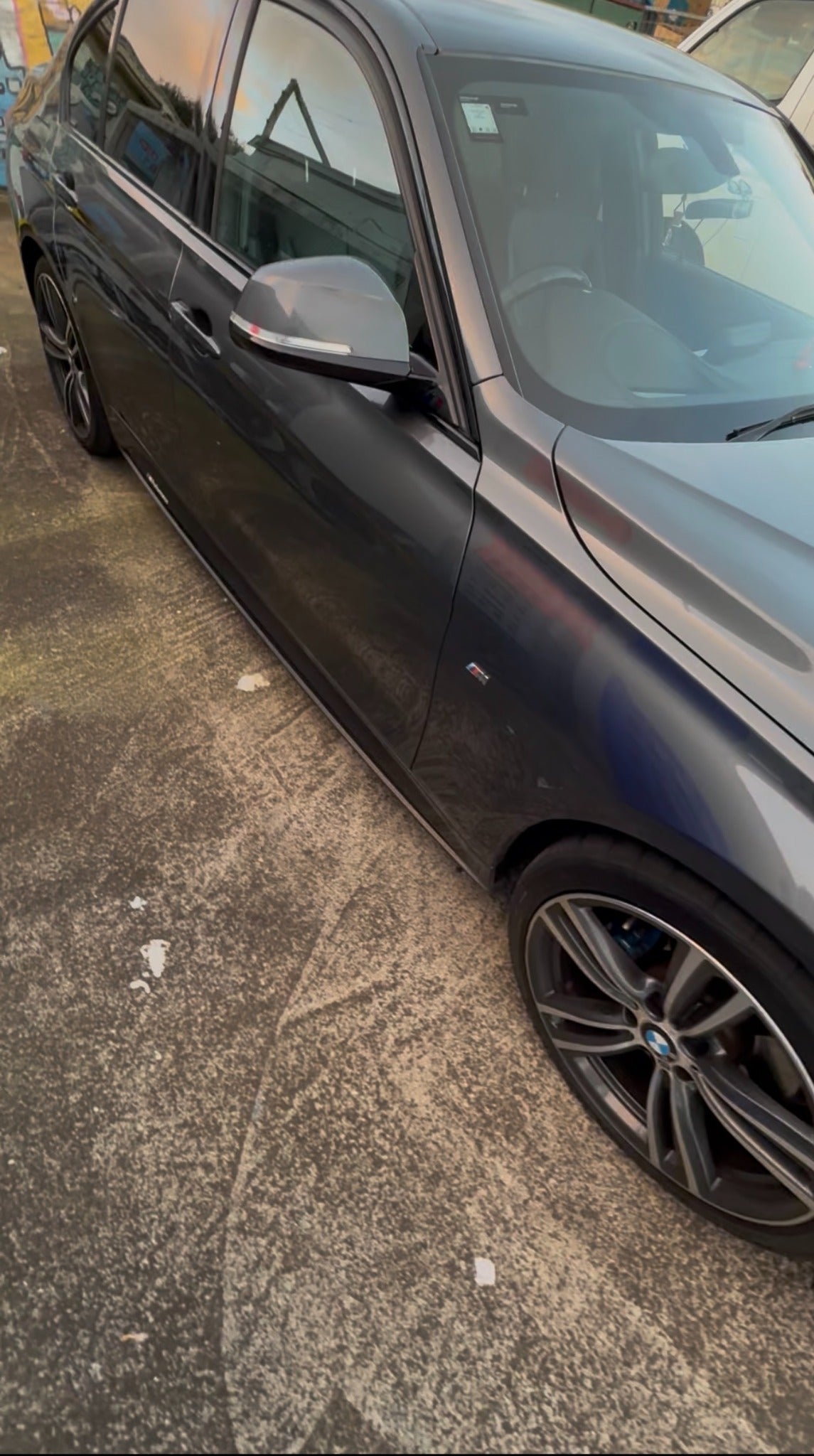 Grey BMW side view before carbon mirror cap upgrade photographed for Apex Euro Styling